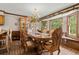 Formal dining room with elegant chandelier, large dining table, and bay windows at 3500 Thunderwood Ln, Snellville, GA 30039