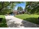 Beautiful home exterior with a long driveway, manicured lawn, and mature trees providing shade at 3500 Thunderwood Ln, Snellville, GA 30039