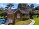 Charming brick home exterior featuring well-maintained landscaping and multiple garage doors at 3500 Thunderwood Ln, Snellville, GA 30039