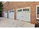 Spacious three-car garage with white doors and black hardware, providing ample parking at 3500 Thunderwood Ln, Snellville, GA 30039