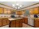 Kitchen with center island, brick floors, stainless appliances, and wood cabinets at 3500 Thunderwood Ln, Snellville, GA 30039
