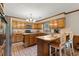 Spacious kitchen with breakfast bar, brick floors, and wood cabinets at 3500 Thunderwood Ln, Snellville, GA 30039