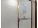 Shower featuring white wall tiles, a framed glass door and a chrome shower head at 3500 Thunderwood Ln, Snellville, GA 30039