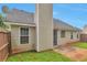 Exterior shot featuring a fenced in backyard with green grass and the home's siding and windows at 420 Spring Lake Ter, Covington, GA 30016