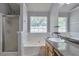 Bathroom with a garden tub with tile surround, glass shower, granite countertops and wood cabinets at 420 Spring Lake Ter, Covington, GA 30016