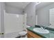 Bathroom with a shower-tub combo, commode, and wood vanity with a green countertop and sink at 420 Spring Lake Ter, Covington, GA 30016