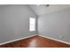Bedroom with gray walls, wood-look floors, vaulted ceiling, and a window for natural light at 420 Spring Lake Ter, Covington, GA 30016