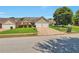 Suburban home with a well-kept lawn, driveway, two-car garage, and mature trees at 420 Spring Lake Ter, Covington, GA 30016