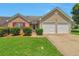 Charming home featuring a well-maintained lawn, brick accents, and a two-car garage at 420 Spring Lake Ter, Covington, GA 30016
