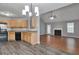 Open-concept kitchen with wood cabinets adjacent to the living area with fireplace at 420 Spring Lake Ter, Covington, GA 30016