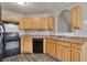 Well-lit kitchen with wood cabinets, modern appliances, and updated countertops at 420 Spring Lake Ter, Covington, GA 30016