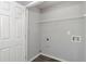 Bright laundry room featuring wood-look floors, shelving, and modern washer/dryer hookups at 420 Spring Lake Ter, Covington, GA 30016