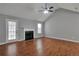 Comfortable living room featuring a fireplace, wood floors, and access to the outdoors at 420 Spring Lake Ter, Covington, GA 30016