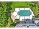 Aerial view of a rectangular pool with a spa, surrounded by a stone patio, grass, and mature trees at 4356 N Buckhead Ne Dr, Atlanta, GA 30342