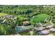 Aerial view of sports field with basketball and tennis courts in a community with lush trees at 580 Lilburn School Rd, Lilburn, GA 30047