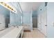 Bathroom with a soaking tub, glass shower, and double vanity with great lighting at 580 Lilburn School Rd, Lilburn, GA 30047