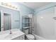 Clean bathroom with a white vanity, toilet, and shower-tub combination at 580 Lilburn School Rd, Lilburn, GA 30047