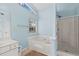 Bathroom with a soaking tub, glass shower, and a modern vanity at 580 Lilburn School Rd, Lilburn, GA 30047