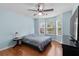 Bedroom featuring a ceiling fan, light-blue walls, and bay windows providing natural light at 580 Lilburn School Rd, Lilburn, GA 30047