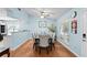 Bright dining area with a large table and chairs, adjacent to an open kitchen at 580 Lilburn School Rd, Lilburn, GA 30047