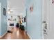 Welcoming entryway with light blue walls and hardwood floors leading to a sunlit living area with a fireplace at 580 Lilburn School Rd, Lilburn, GA 30047