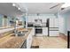 Well-lit kitchen with granite countertops, stainless steel appliances, and white cabinets at 580 Lilburn School Rd, Lilburn, GA 30047