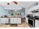 Charming kitchen featuring granite countertops, stainless steel appliances, and white cabinets at 580 Lilburn School Rd, Lilburn, GA 30047