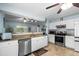 Well-lit kitchen featuring granite countertops, stainless steel appliances, and white cabinets at 580 Lilburn School Rd, Lilburn, GA 30047