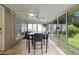 Enclosed sunroom with tile floors, floor to ceiling windows, and a ceiling fan at 580 Lilburn School Rd, Lilburn, GA 30047