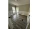Living room with decorative wall panels, two windows and modern flooring at 6830 Pawnee Trl Se, Acworth, GA 30102