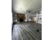 Spacious living room with beautiful floors, a ceiling fan, and a stone fireplace at 6830 Pawnee Trl Se, Acworth, GA 30102