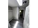 Bright walk-in closet with overhead lighting leading into a bright bathroom at 6830 Pawnee Trl Se, Acworth, GA 30102