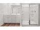 Bathroom featuring double sinks, white cabinets, and a glass-enclosed shower at 2472 Cotton Ln, Douglasville, GA 30135