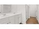 Bathroom featuring double sinks, white cabinets, and a glass-enclosed shower at 2472 Cotton Ln, Douglasville, GA 30135