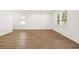 Open-concept living space with hardwood floors and large windows at 2472 Cotton Ln, Douglasville, GA 30135