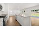 Open concept kitchen and living space with wood-look floors and sliding glass door to the back yard at 2472 Cotton Ln, Douglasville, GA 30135