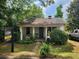 Exterior of charming single-story home with inviting front porch and lush landscaping at 2880 Elizabeth Se St, Smyrna, GA 30080