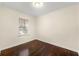 Bedroom featuring hardwood floors, neutral walls, and a window with blinds for natural light at 2903 Akron Street, East Point, GA 30344