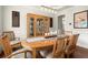Elegant dining room features hardwood floors, natural light, and decorative cabinet for storing dinnerware at 3070 Jardin Nw Ln, Kennesaw, GA 30152