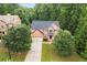 Charming brick home with a two-car garage, surrounded by mature trees and a well-maintained lawn at 3070 Jardin Nw Ln, Kennesaw, GA 30152