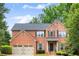 Lovely two-story brick home with a well-kept lawn, two-car garage and welcoming front entrance at 3070 Jardin Nw Ln, Kennesaw, GA 30152