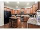 Well-equipped kitchen with granite counters, a central island with seating, stainless steel appliances, and hardwood floors at 3070 Jardin Nw Ln, Kennesaw, GA 30152