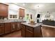 Bright kitchen features granite counters, center island with stools, and an open view to the living room at 3070 Jardin Nw Ln, Kennesaw, GA 30152
