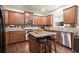 Modern kitchen features granite countertops, stainless appliances, island with stools, and hardwood floors at 3070 Jardin Nw Ln, Kennesaw, GA 30152