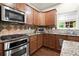 Modern kitchen features stainless steel appliances, granite countertops, a tiled backsplash, and ample cabinet space at 3070 Jardin Nw Ln, Kennesaw, GA 30152
