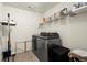 Well-equipped laundry room with modern washer and dryer and shelving at 3070 Jardin Nw Ln, Kennesaw, GA 30152