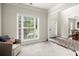 Bright living room with large windows, neutral carpet and open entryway to the foyer at 3070 Jardin Nw Ln, Kennesaw, GA 30152