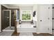 Beautiful bathroom features a glass-enclosed shower, a soaking tub, neutral tile, and a bright window at 3070 Jardin Nw Ln, Kennesaw, GA 30152