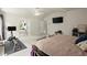 Open main bedroom features a wall-mounted television, comfortable furnishings, and an adjacent en-suite bathroom at 3070 Jardin Nw Ln, Kennesaw, GA 30152