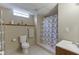 Compact bathroom with tile flooring, shower with curtain and storage at 1545 Smoke Hill Dr, Hoschton, GA 30548